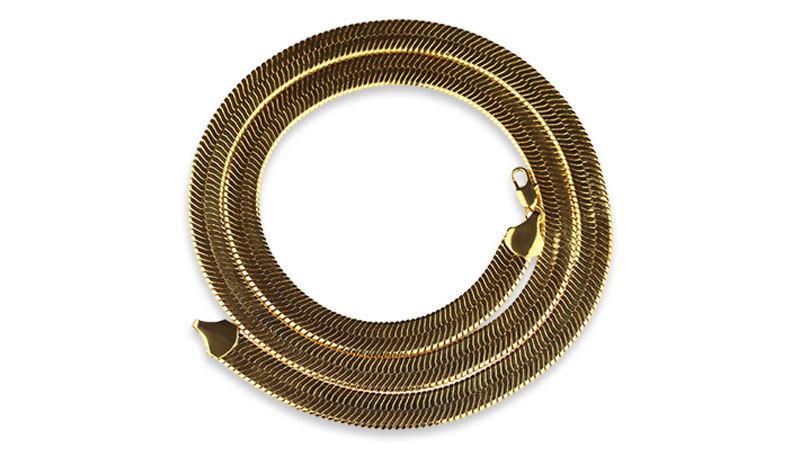 A gold snake chain coiled in a circular shape.