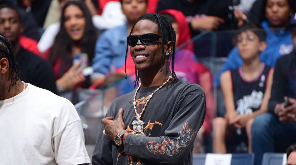 Travis Scott’s jewelry style is defined by rugged street luxury, combining dark-toned aesthetics