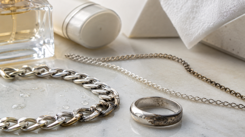 Sterling silver tarnishes when its surface reacts with sulfur