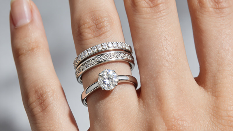 The engagement ring goes first, followed by wedding band.